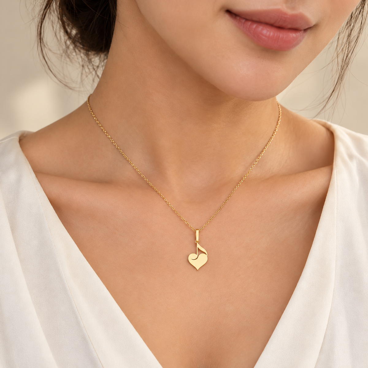 Pendentif doré cœur et note de musique