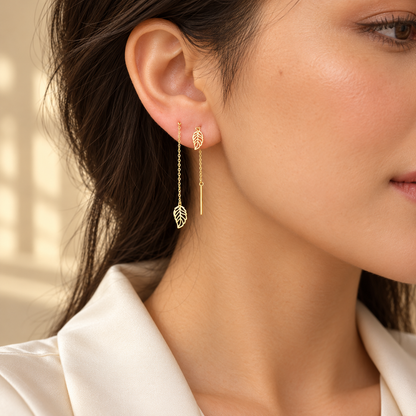 Boucles d’oreilles traversantes dorées à feuilles